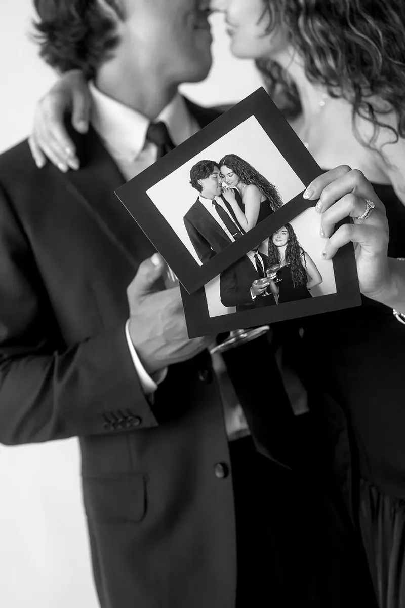 Guests holding a framed photo strip