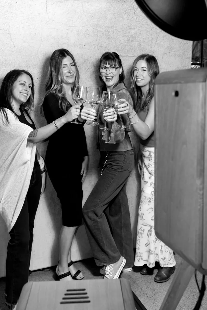 A group of guests raising a toast at the booth