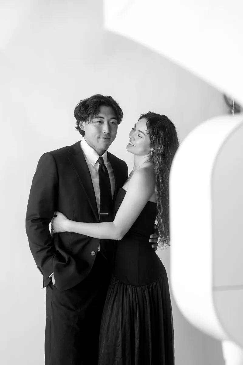 Two guests posing beside a photo booth