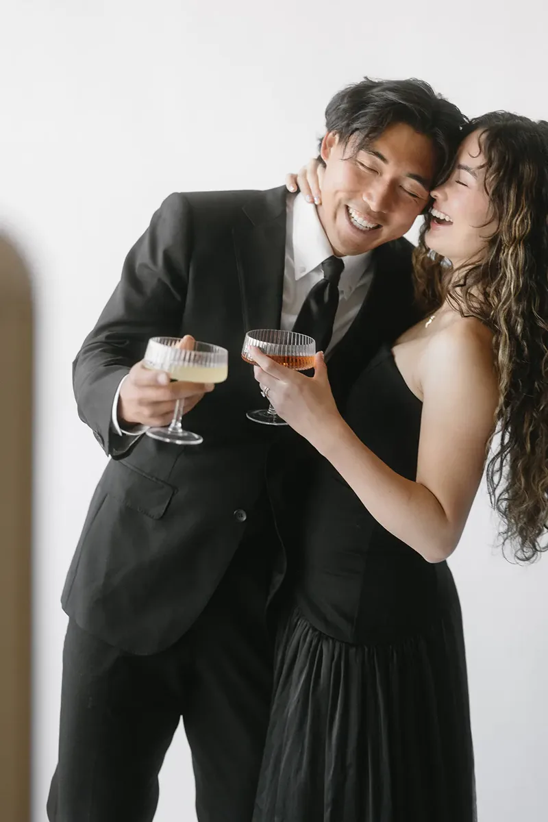Two guests sharing a drink and a photo strip